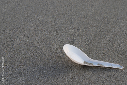 Plastic spoon on the beach,garbage on the beach