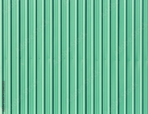 Green galvanized steel plate as fence wall,Seamless abstract background green with vertical lines