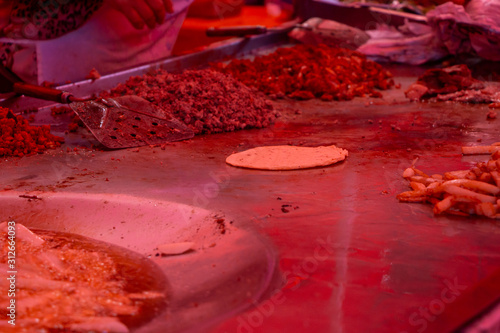 street tacos and french fries being cooked in a street market