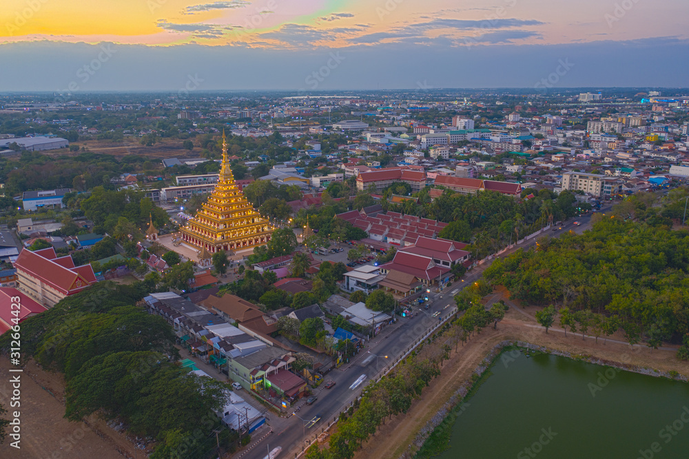 Aerial view eastern Khon Kaen cityscape with Phra Mahathat Kaen Nakhon, Wat Nong Wang at sunset sky in Thailand.