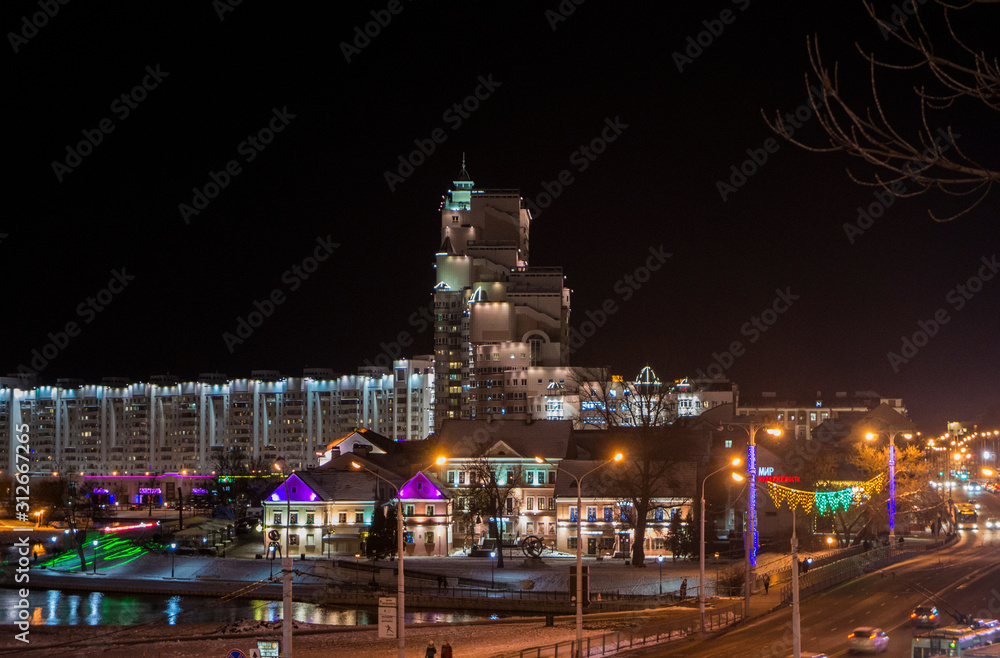 Christmas night neon glowing cityscape. Buildings with decorations and lamps. Minsk Belarus. December 31 2019