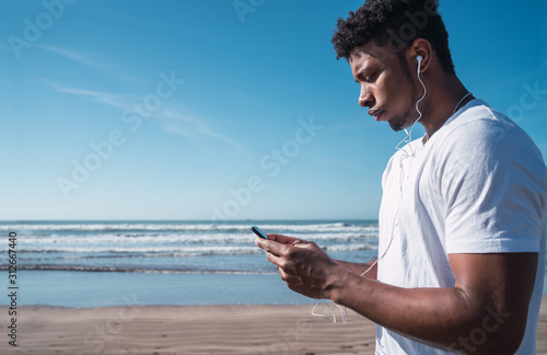 Athletic man using his mobile phone.