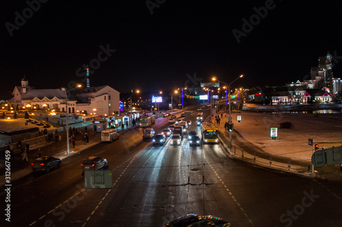 Night road with cars in the city. Christmas city with bright lights. Minsk Belarus. December 31 2019 © Payllik