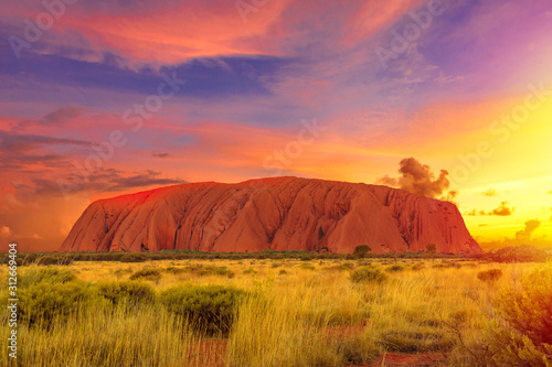 Canvas Print Colorful clouds at sunset sky over Ayers Rock in Uluru-Kata Tjuta National Park - at Living Cultural Landscape, Australia, Northern Territory