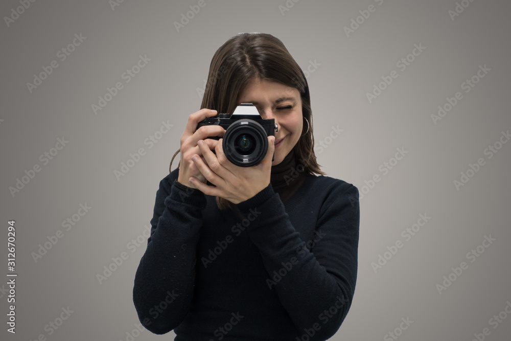 Elegant caucasian pretty girl taking a picture with mirrorless camera. Elegant caucasian pretty girl taking a picture with mirrorless camera.