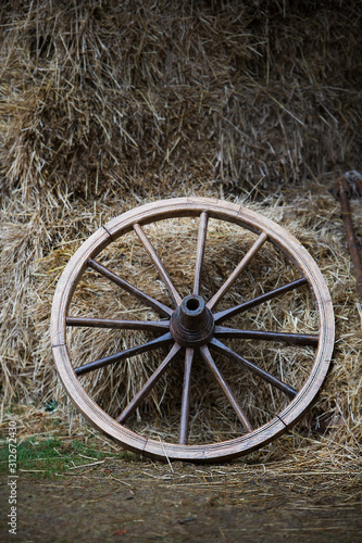 old wagon wheel in the hay
