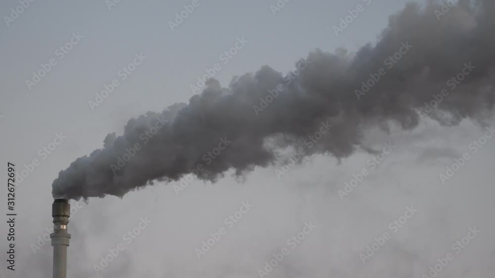 Dark hot smoke coming out of an industrial chimney of a chemical plant. Air pollution and global warming Dark hot smoke coming out of an industrial chimney of a chemical plant. Air pollution and global warming