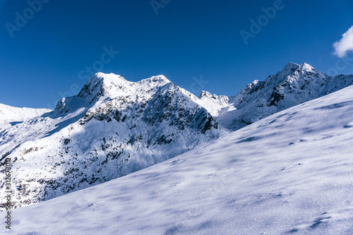 The snowy mountains, the nature and the landscape of the Valtellina after the first snowfall of the season in the Alps, near the town of Tartano, Italy - November 2019. © Roberto