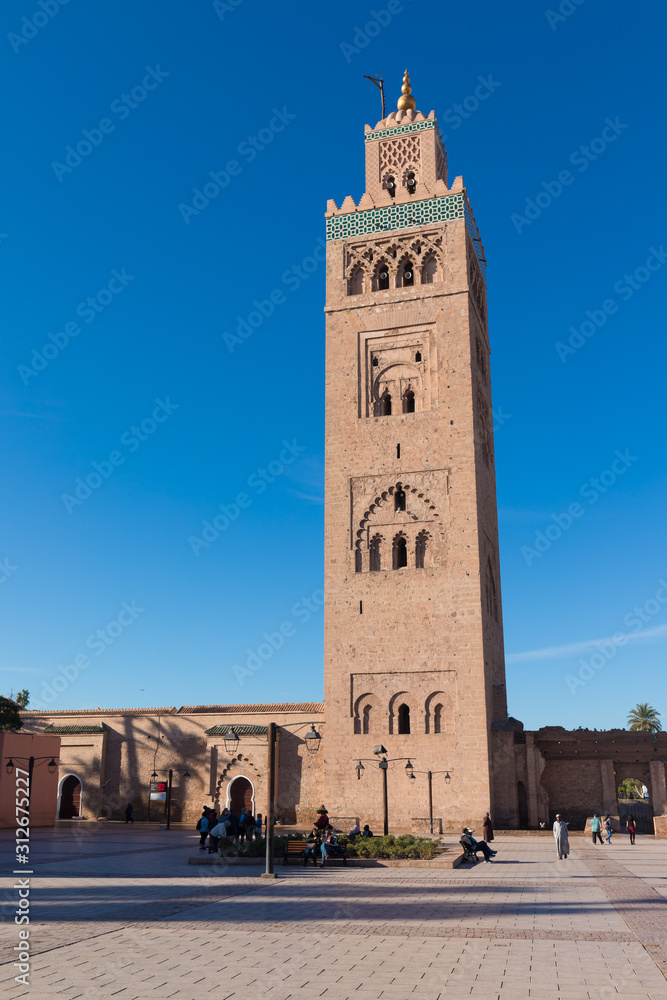 Koutoubia Mosque is the largest mosque in Marrakech, Morocco. It is also known by several other names, such as Jami ‘al-Kutubiyya, Koutoubia, Kutubiya, Kutubiyya and the Booksellers’ Mosque. Sunny day