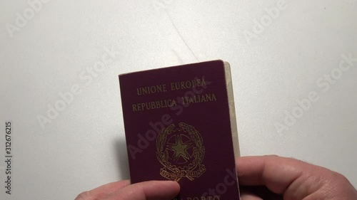 Taking and opening Italin Passport with hand