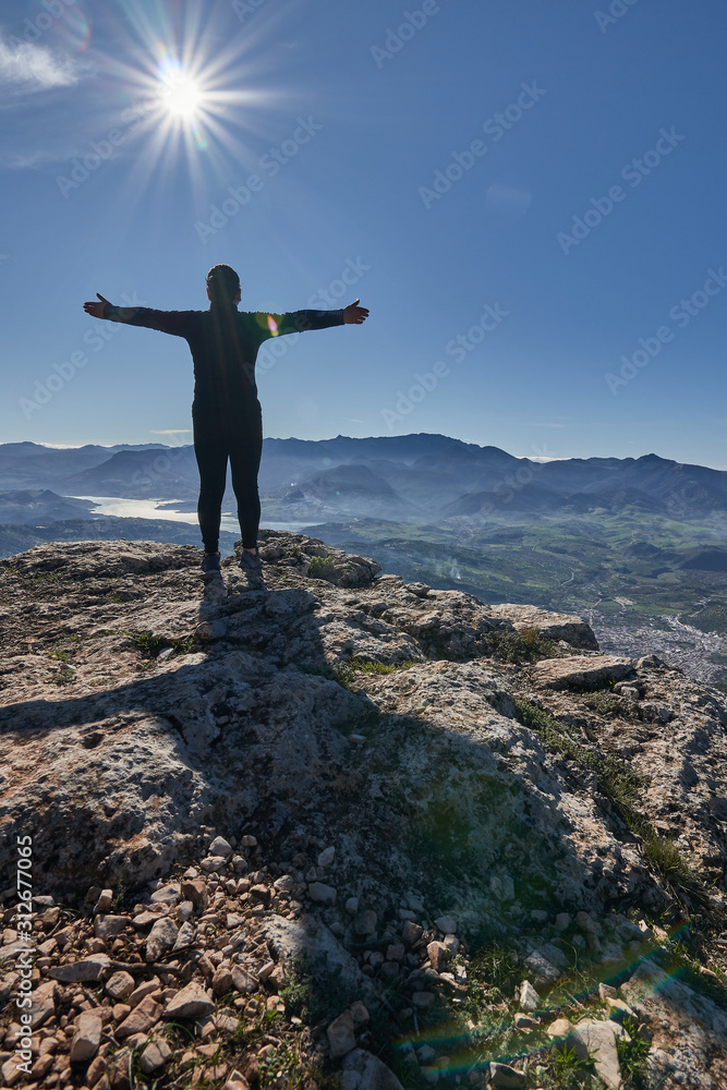 woman loving nature and sun in the mountain woman loving nature and sun in the mountain