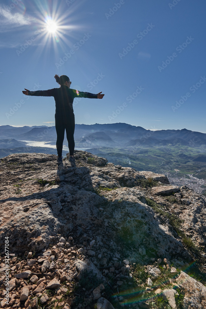 woman loving nature and sun in the mountain woman loving nature and sun in the mountain