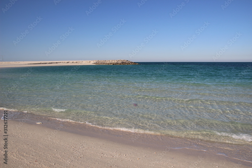 Empty calm sea bay with sand beach in sunny day