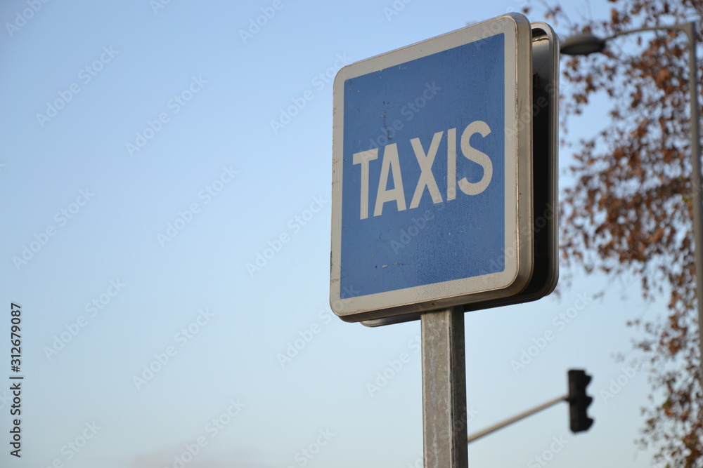 Cab sign on background of blue sky