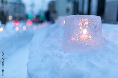 Ice lantern with candle burning inside