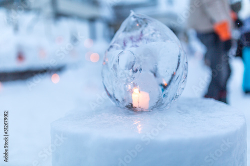 Ice lantern with candle burning inside