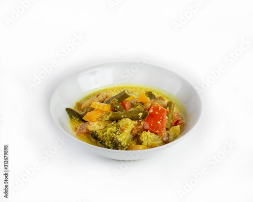 Thick soup with chicken and vegetables on a white background