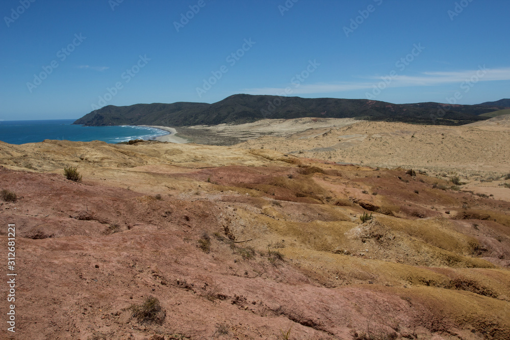 The moon-like colored clay hills of the New Zealand's Cape Reinga in Northland, and Te Werahi Beach