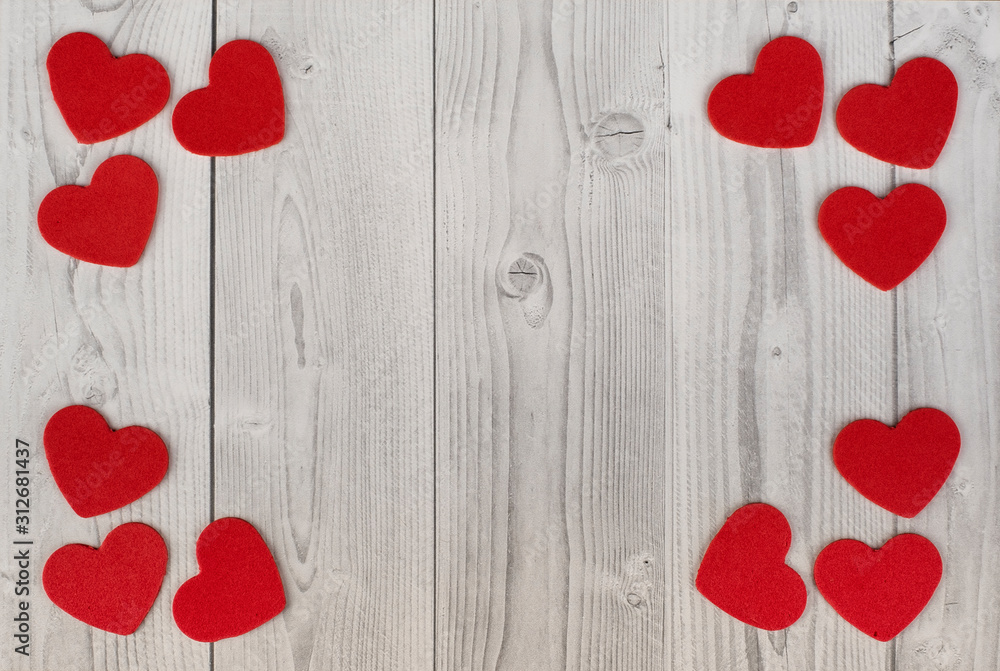 red hearts in the corners of a white and grey wooden background. concept of valentine's day red hearts in the corners of a white and grey wooden background. concept of valentine's day