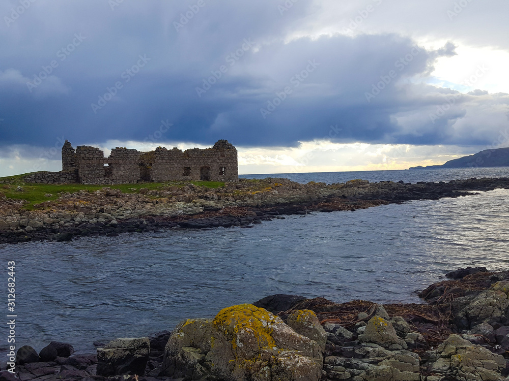 Coast in island Rathlin Northern Ireland and ruin in background Coast in island Rathlin Northern Ireland and ruin in background