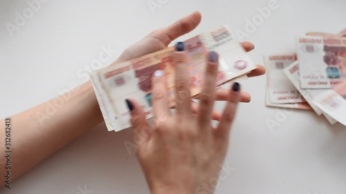 girl counting russian money five thousandths rubles photo