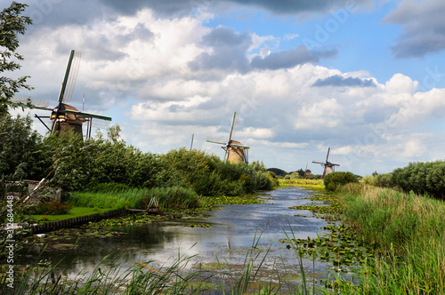 Dutch landscape with three mills and creek