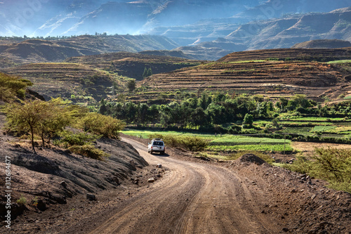 ETHIOPIA, LALIBELA, 01-31-2019. 4 wheel drive car on its way through a spectecular mountain scenery on a gravel road between Mekelle and Lalibela
