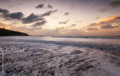 Sunrise over Langland Bay, a European Blue Flag awarded beach on the Gower peninsula, Swansea, South Wales, UK