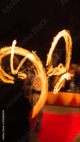 Fire Dancer street performance trail fire red yellow © Valentin