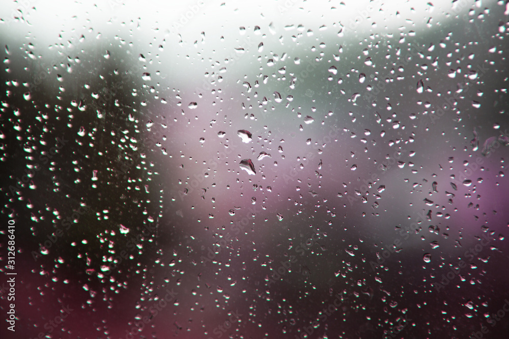 Blurred background of drops on the window. Abstract purple background.