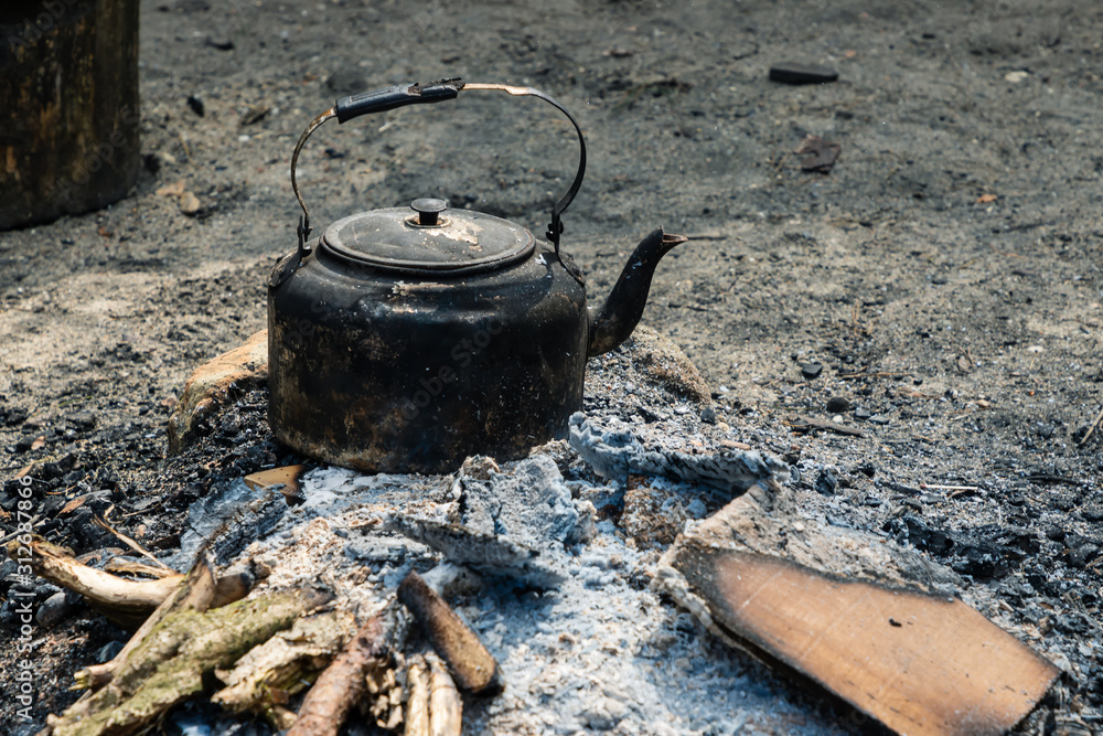 Extinguished fireplace with a teakettle Extinguished fireplace with a teakettle