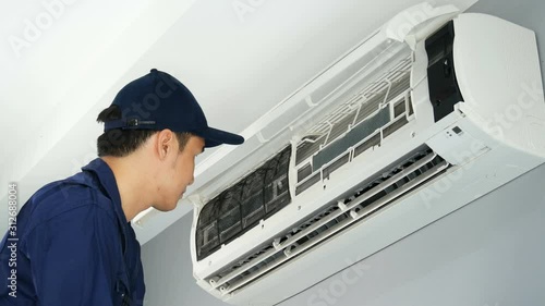Technician service placing back clean filter into air conditioner