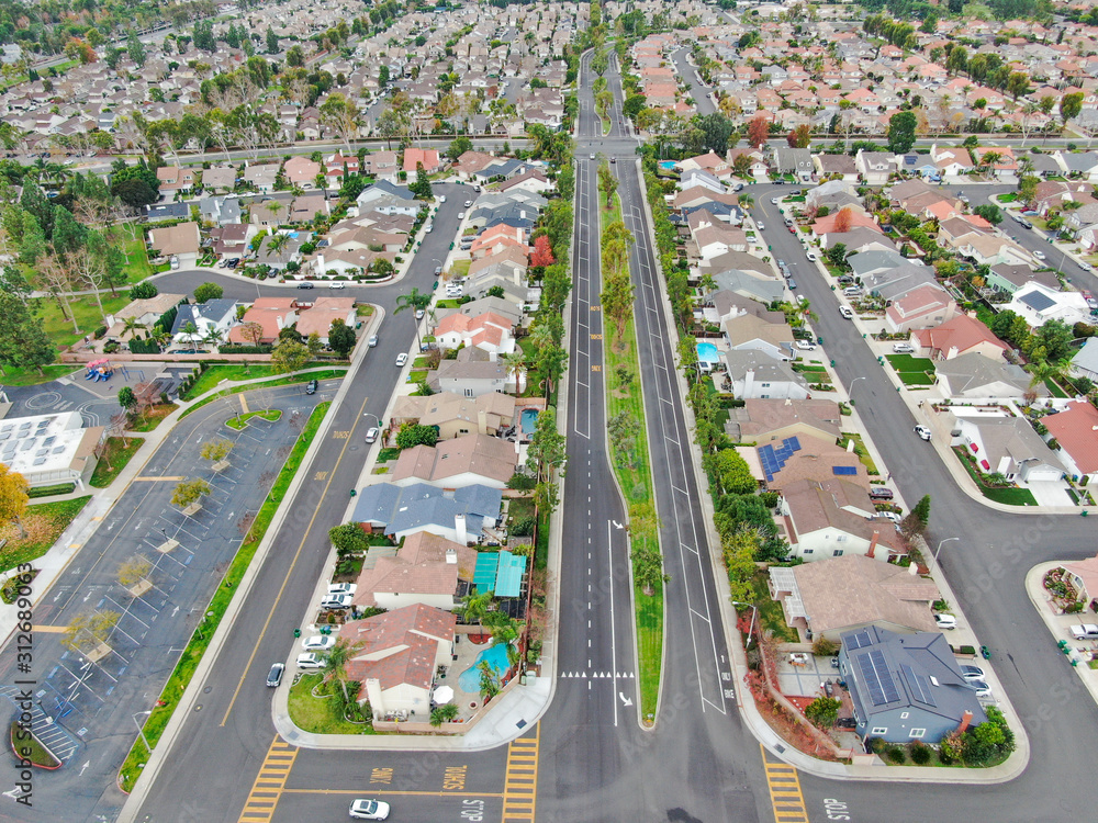 Aerial view of urban sprawl. Suburban packed homes neighborhood with road. Vast subdivision in Irvine, California, USA Aerial view of urban sprawl. Suburban packed homes neighborhood with road. Vast subdivision in Irvine, California, USA