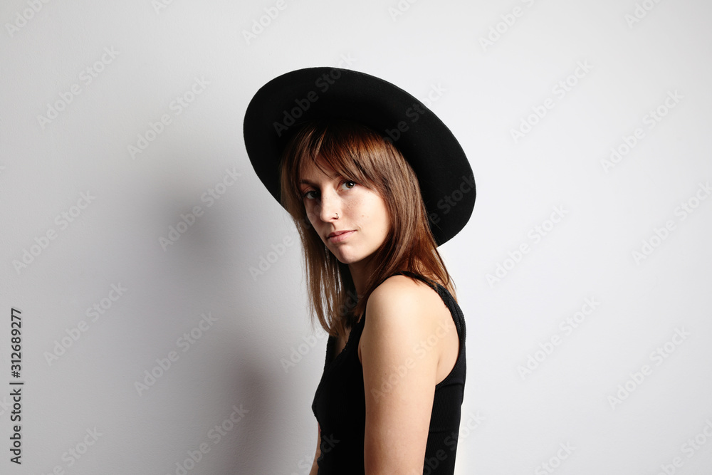 A person with the hand on the head wearing black hat. Isolated. A person with the hand on the head wearing black hat. Isolated.