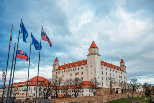 Bratislava Castle with flags of Slovakia and the European Union in Bratislava.