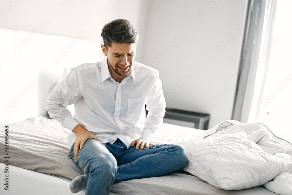 portrait of young man sitting on sofa portrait of young man sitting on sofa