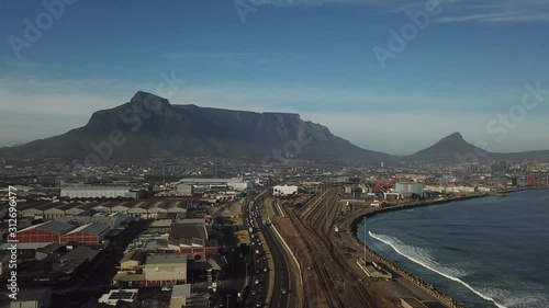 4K high quality aerial sunny morning footage of industrial Transnet harbour, Table Mountain, busy highways, city center, Atlantic Ocean Table Bay panorama, Western Cape, Cape Town, South Africa