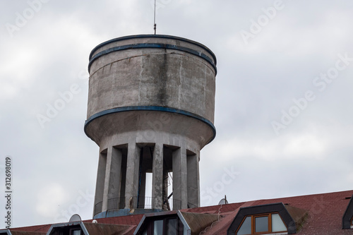 Water tower close-up. It is used where water pressure is not sufficient. Made of concrete.
