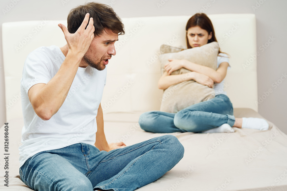 couple sitting on sofa and watching tv couple sitting on sofa and watching tv