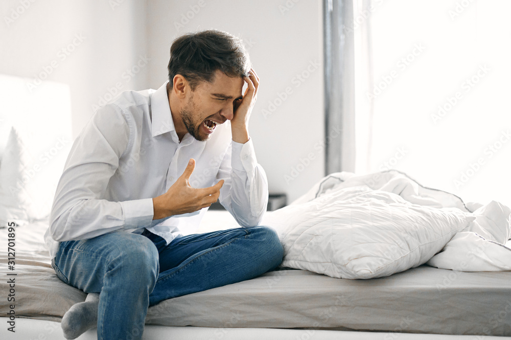 man sitting on sofa at home man sitting on sofa at home