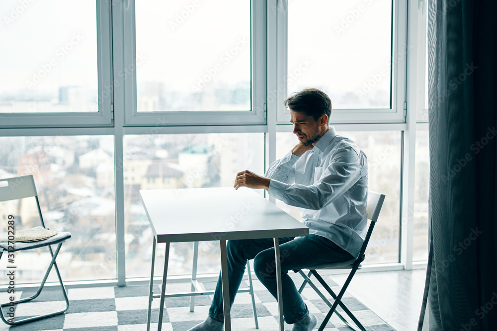 businessman sitting on chair and looking at camera