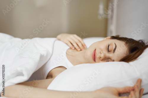 portrait of a woman lying on bed and looking at camera