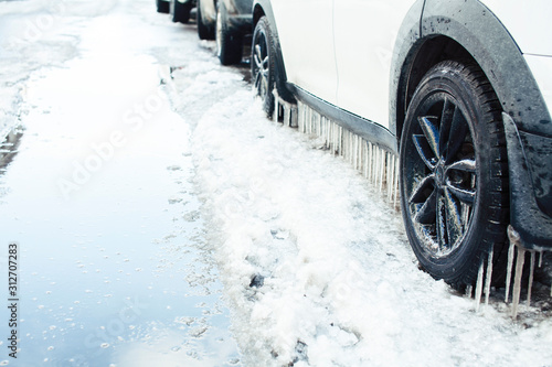 close up photo off car in iciles, a lot of water and snow, seasonal issues concept © iordani