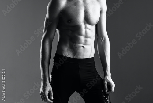 bodybuilder posing on black background