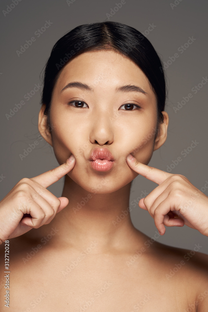 young woman with finger on her lips young woman with finger on her lips