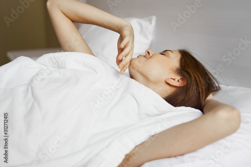 young woman lying on bed