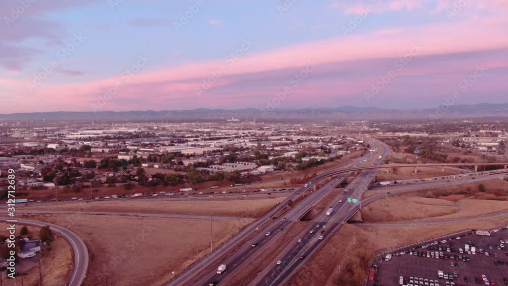 Denver highways and mountain horizon during pink sunrise high aerial Denver highways and mountain horizon during pink sunrise high aerial