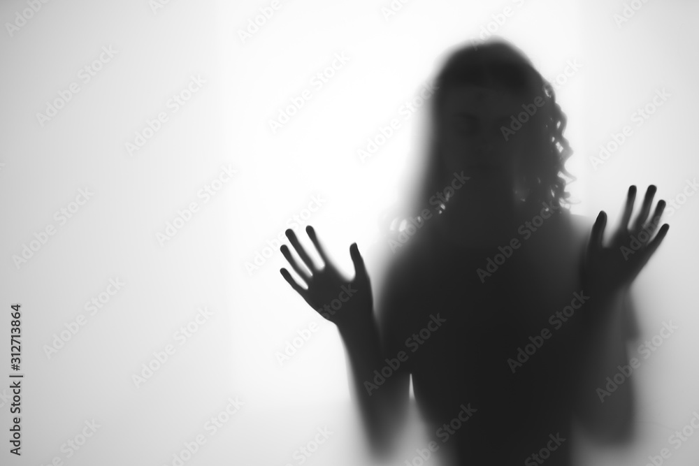silhouette of woman with hands on head
