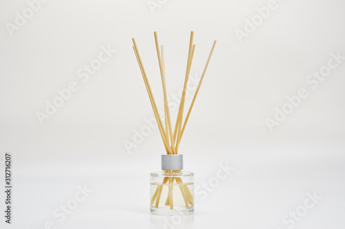 wooden sticks in a jar with essential oil to flavor the room photo