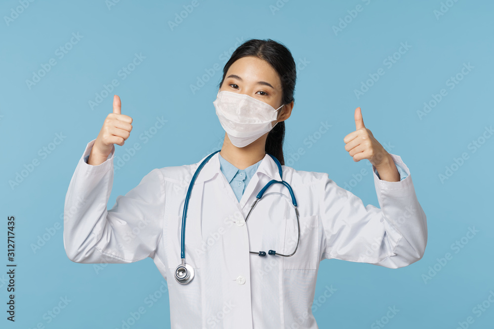 young doctor with thumbs up gesture isolated on white young doctor with thumbs up gesture isolated on white